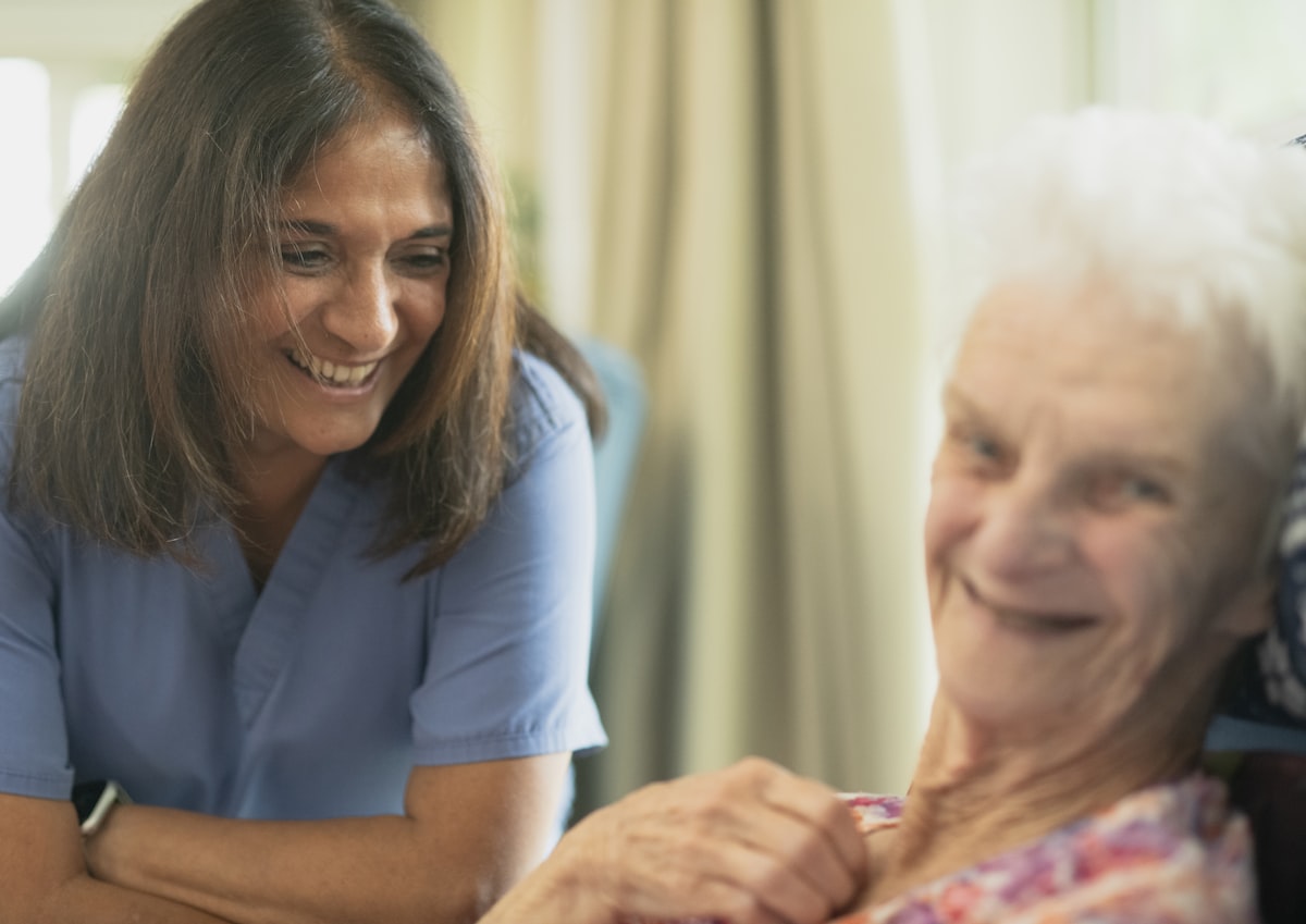 Carer in conversation with an older woman at home