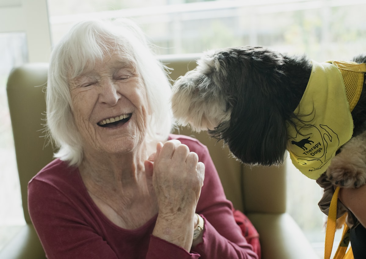 Elderly woman enjoying time with a pet dog